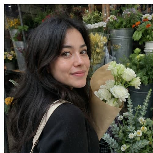 Woman holding flowers at a market